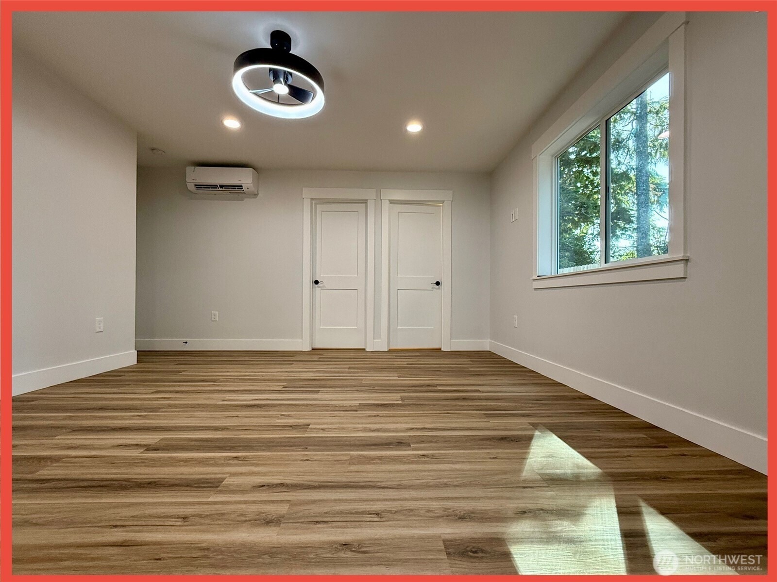 611 Weatherwax Loop Northeast Ocean Shores, WA 98569 - Photo 36 of 39 a view of an empty room with wooden floor and a window