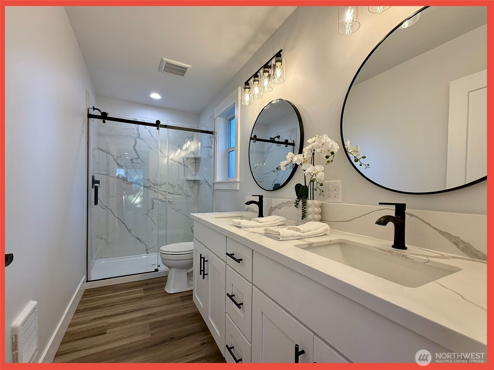 611 Weatherwax Loop Northeast Ocean Shores, WA 98569 - Photo 37 of 39 a bathroom with a toilet a sink and a mirror