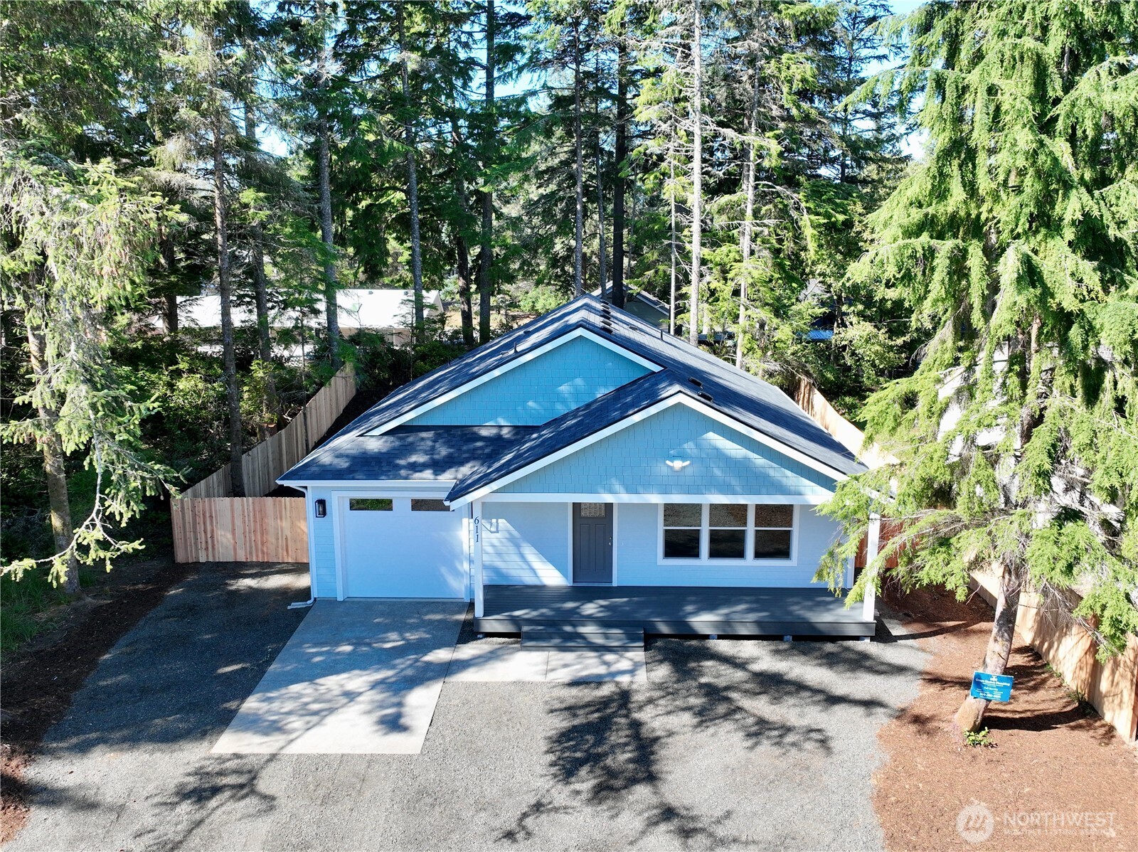 611 Weatherwax Loop Northeast Ocean Shores, WA 98569 - Photo 4 of 39 a front view of a house with a yard