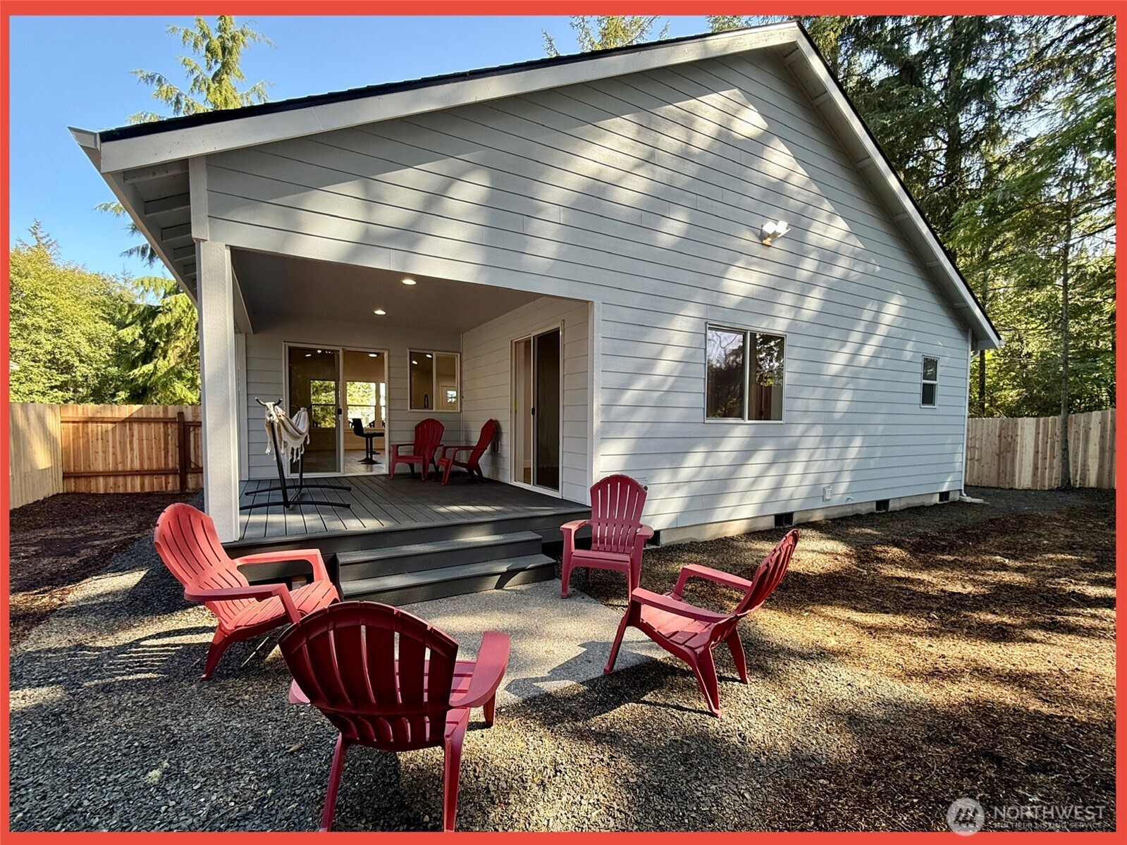 611 Weatherwax Loop Northeast Ocean Shores, WA 98569 - Photo 8 of 39 an outdoor living area with chairs and a table