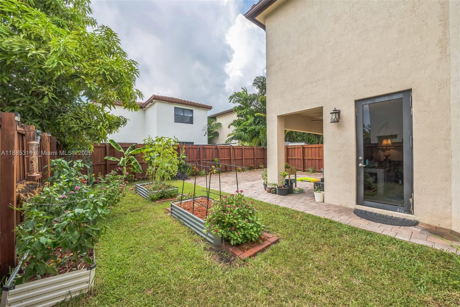 627 Southeast 34th Avenue Homestead, FL 33033 - Photo 11 of 17 a view of a chair and tables in the backyard of the house