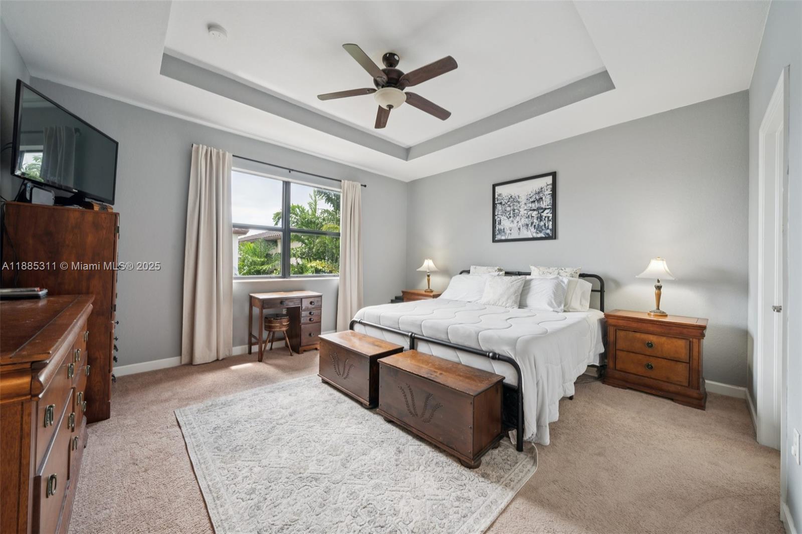 627 Southeast 34th Avenue Homestead, FL 33033 - Photo 7 of 17 a spacious bedroom with a bed a window and a flat screen television