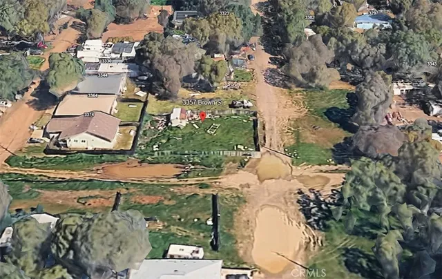 an aerial view of a house with a yard and large trees