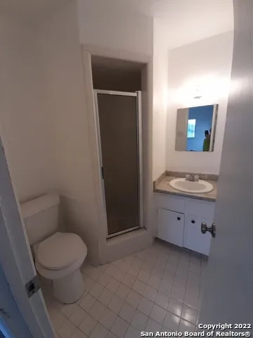 a bathroom with a toilet a sink a vanity and mirror