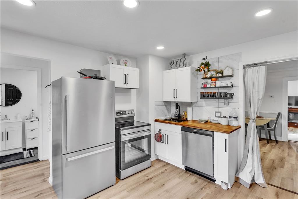 1747 Galilee Road Wampum, PA 16157 - Photo 4 of 32 Brand-new stainless appliances elevate the kitchen with a refined, modern touch.