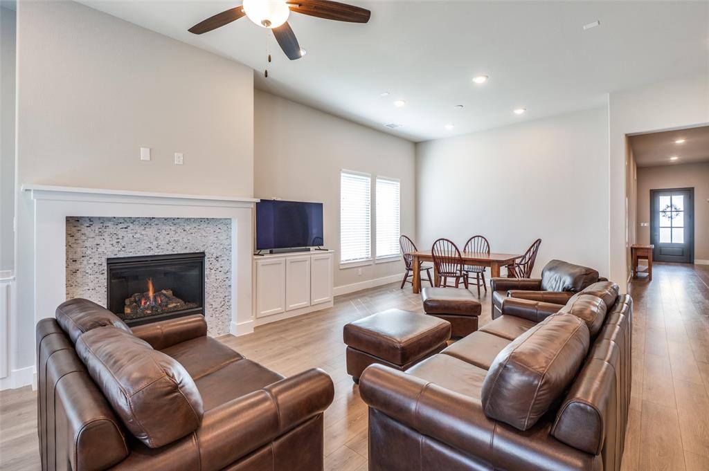 2901 Quinton Street Prosper, TX 75078 - Photo 7 of 24 a living room with furniture and a fireplace