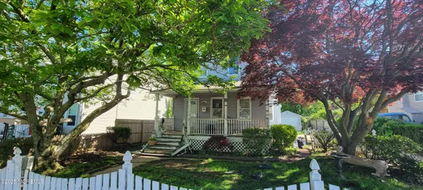 front view of a house with a tree