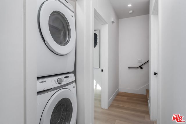 a view of a hallway with washer and dryer