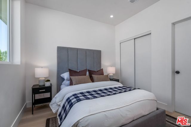 a bedroom with a bed and a lamp