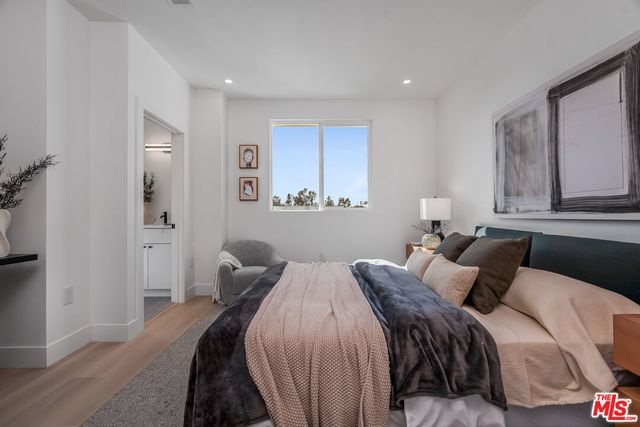 a bedroom with a bed and a mirror