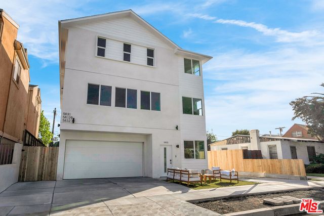 a view of a white building among the street