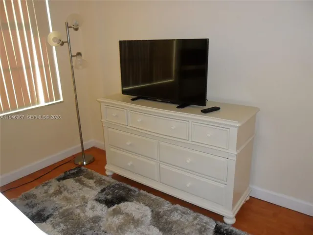 a living room with a bed furniture and a window