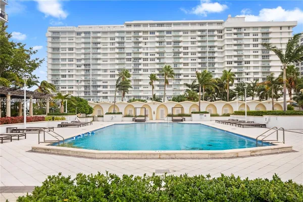 a view of swimming pool with outdoor seating