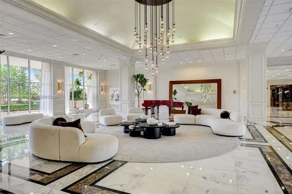 a living room with fireplace furniture and a large window