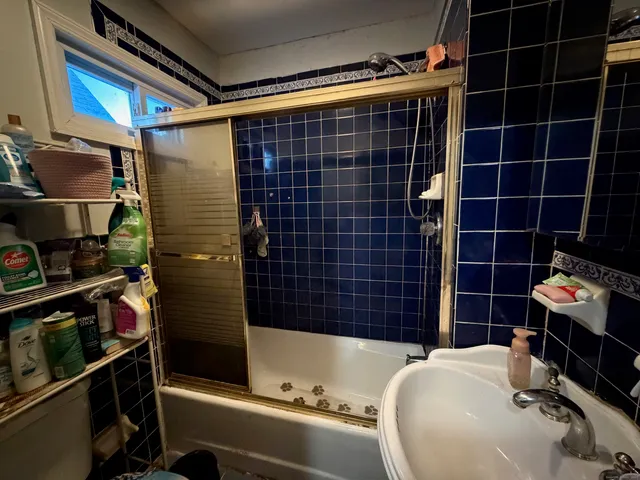 a bathroom with a bathtub and a shower