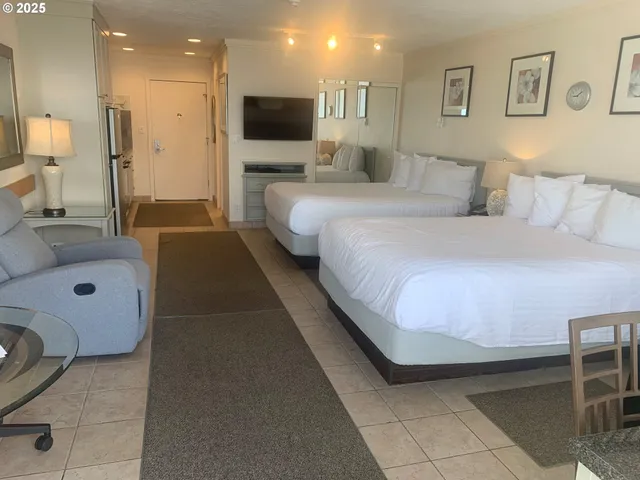 a bedroom with a bed and a flat screen television