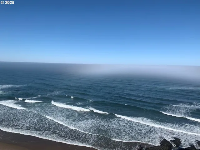 a view of a room with an empty space and window