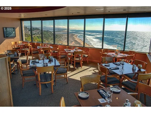 a workspace with furniture large windows and view