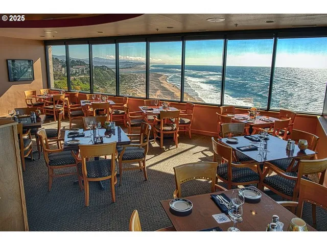 a workspace with furniture large windows and view