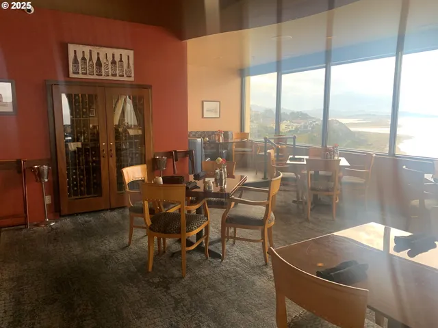 a dining room with furniture and a floor to ceiling window