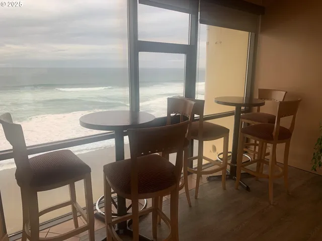 a view of a dining room with furniture and window