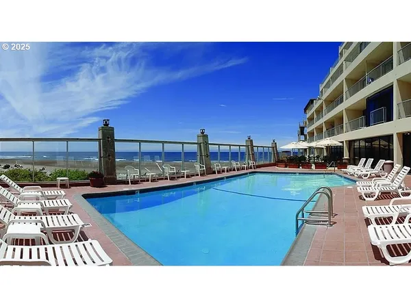 a view of a swimming pool with a yard