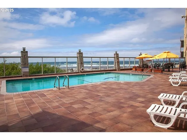 a view of a swimming pool with an outdoor seating
