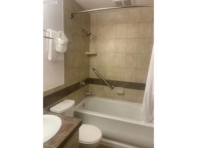 a bathroom with a bathtub and a toilet