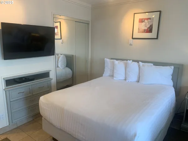 a bedroom with a bed and a flat screen tv