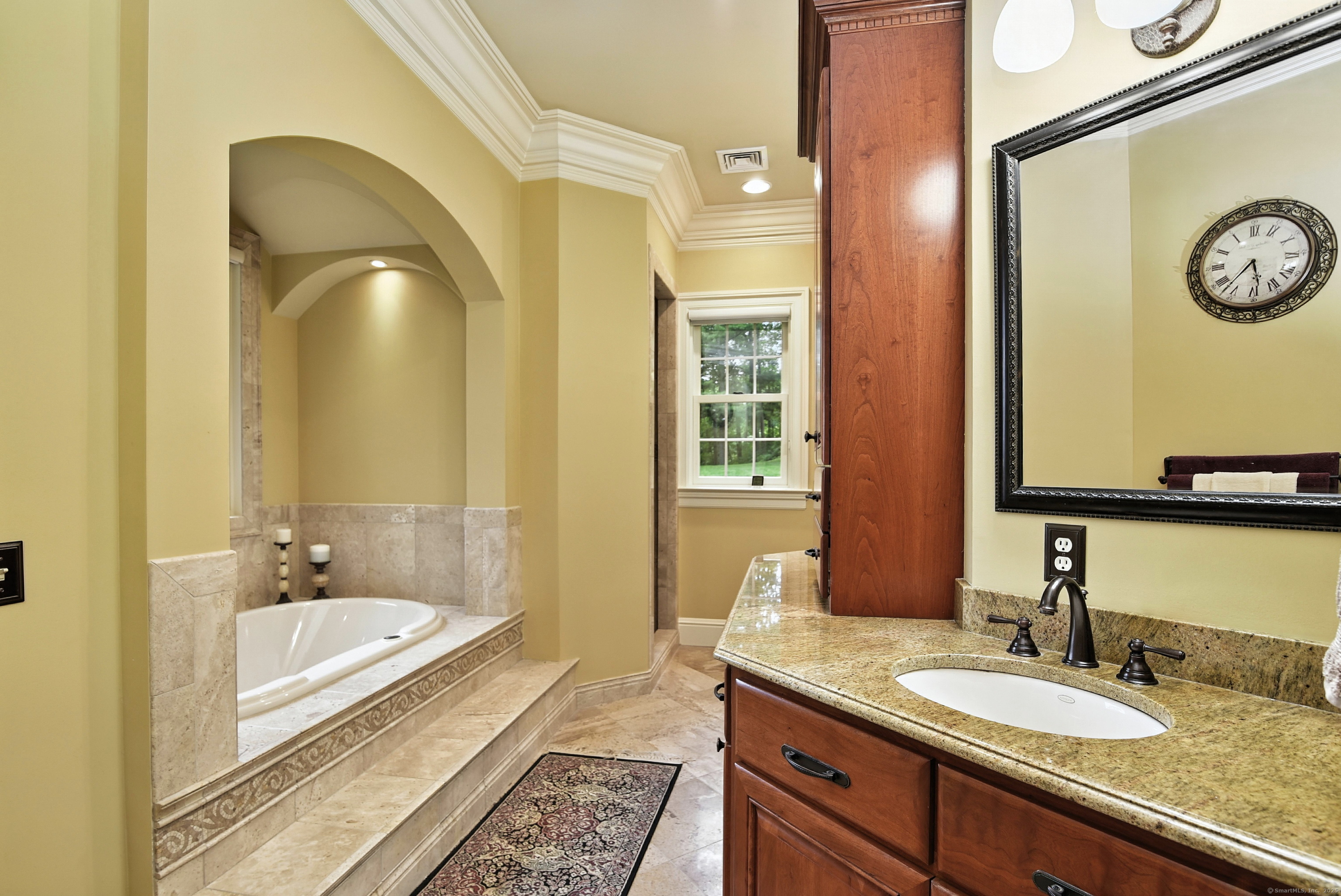 282 Searles Road Pomfret, CT 06259 - Photo 26 of 40 Custom cherry and granite dual vanities in the primary bath offer both upper and lower cabinetry for ample storage.