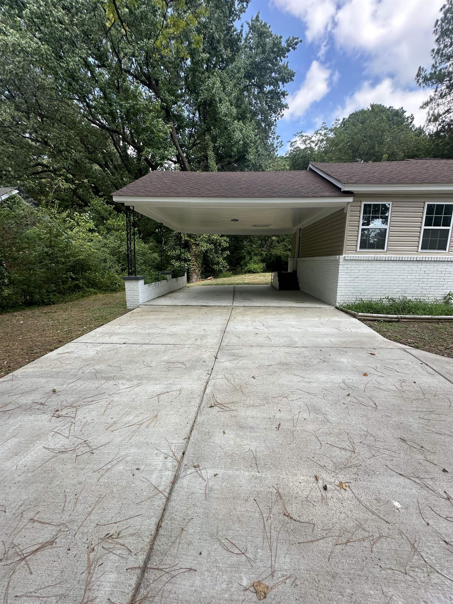 3402 Lakeview Road Memphis, TN 38116 - Photo 18 of 30 View of parking / parking lot featuring concrete driveway and an attached carport
