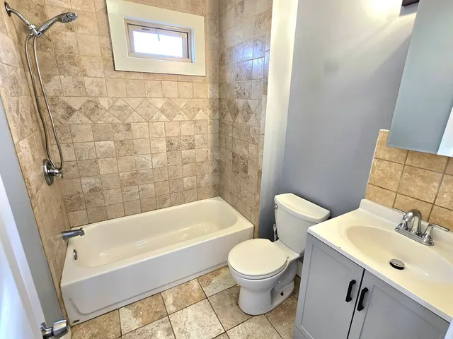 a bathroom with a toilet a sink and bathtub