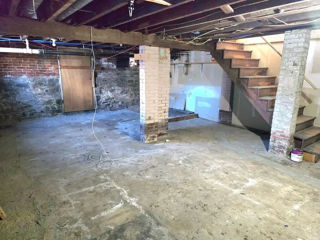 a kitchen with stainless steel appliances a stove a sink a microwave a refrigerator and cabinets