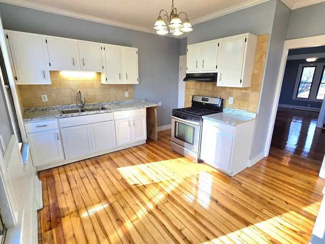 a kitchen with a sink stove and refrigerator