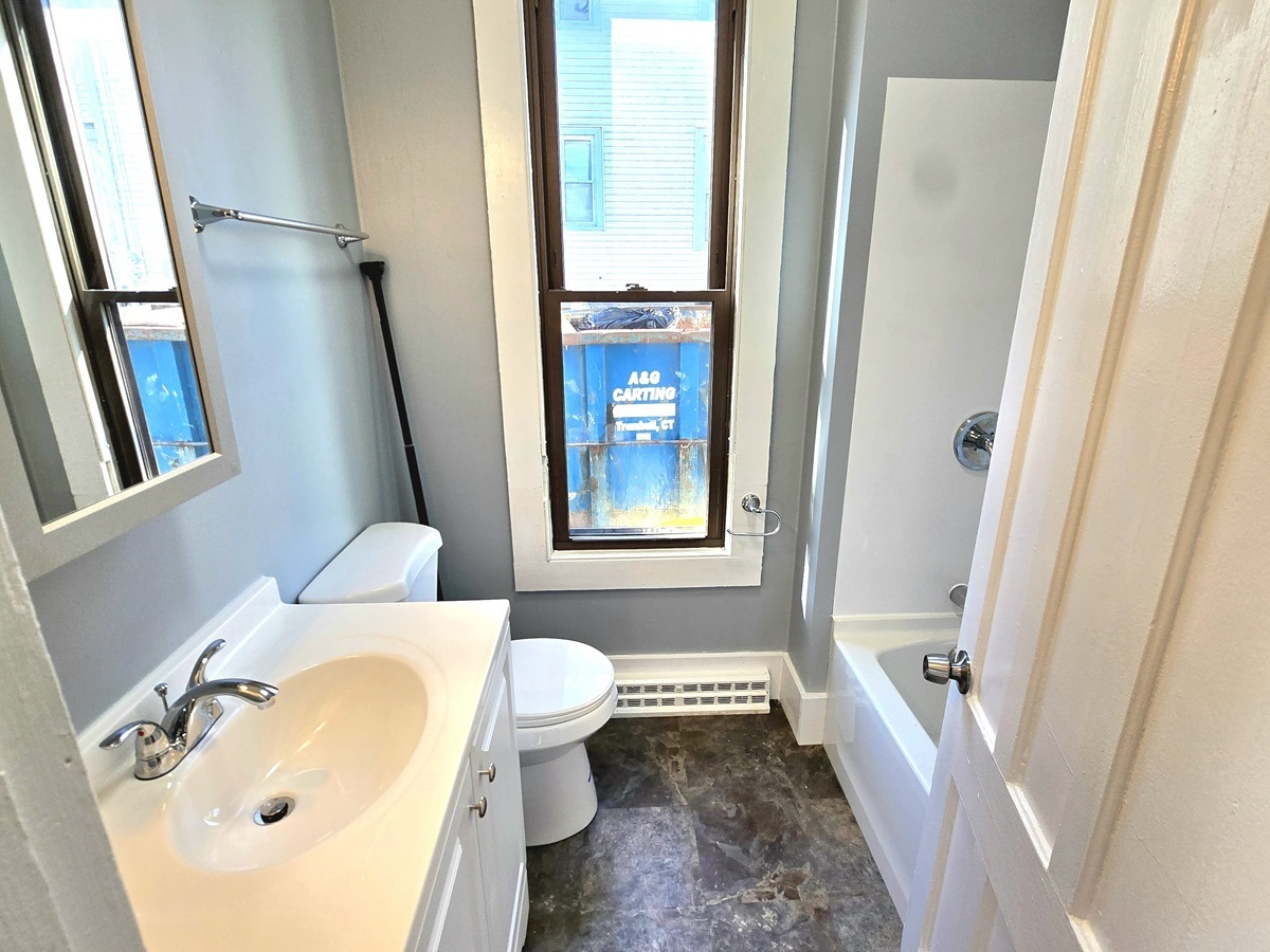 10 Clarkson Street Ansonia, CT 06401 - Photo 27 of 35 a bath room with a sink and a bath tub