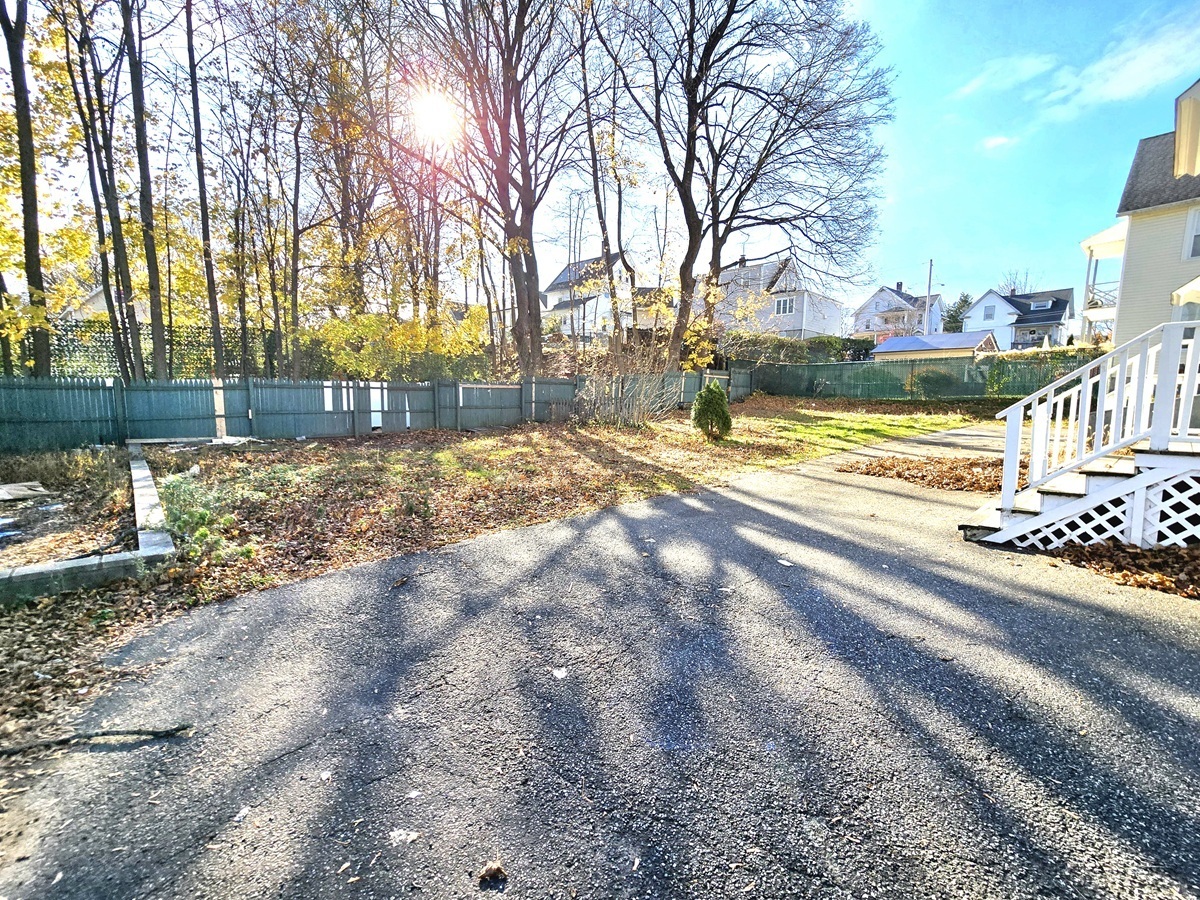 10 Clarkson Street Ansonia, CT 06401 - Photo 31 of 35 a view of a yard with trees on both side of it