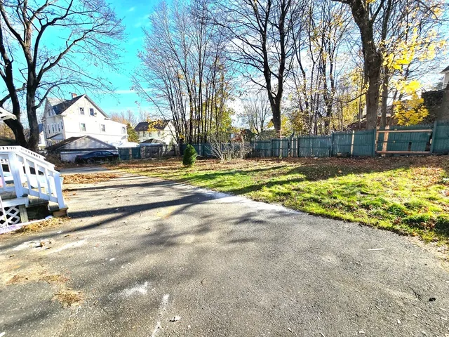 a front view of a house with a tree