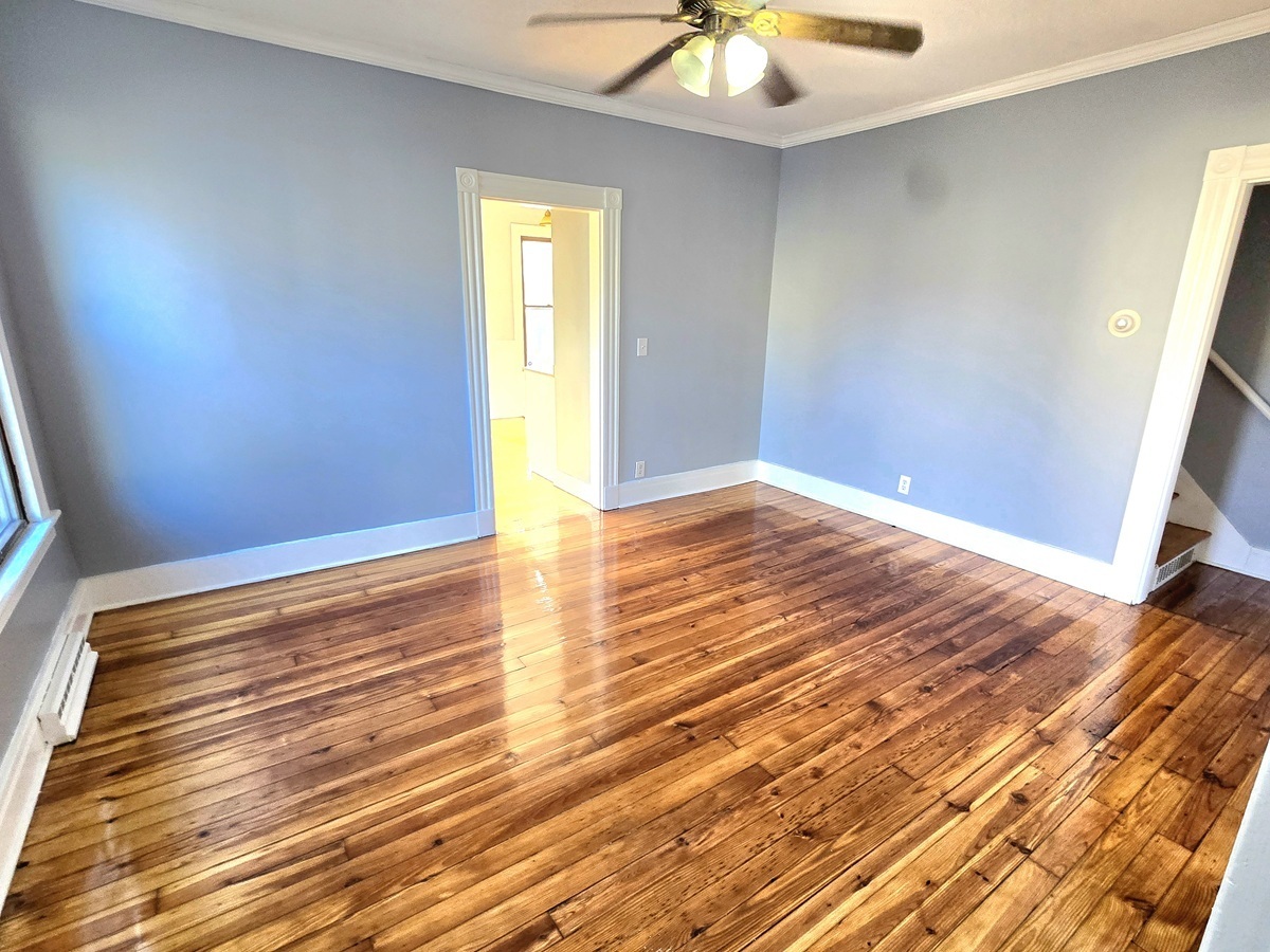 10 Clarkson Street Ansonia, CT 06401 - Photo 4 of 35 a view of empty room with wooden floor and fan