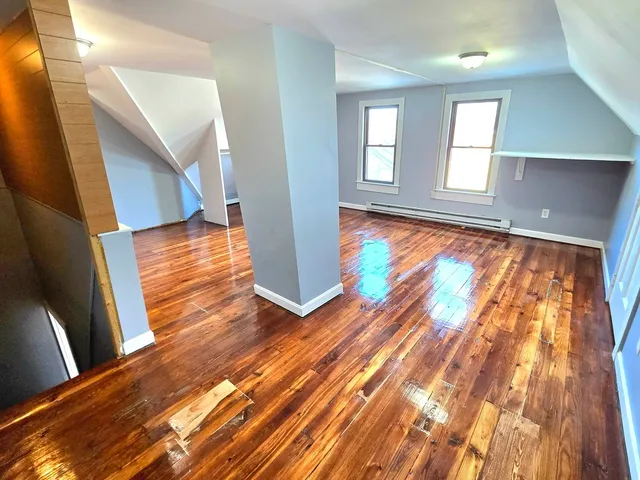 a view of an entryway with wooden floor