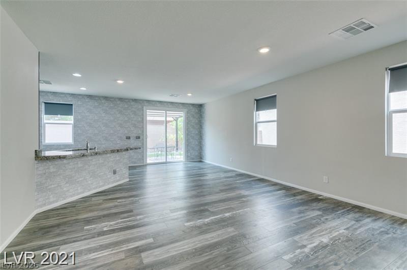 5475 Ordesa Valley Road Las Vegas, NV 89148 - Photo 31 of 35 A spacious living area with resilient flooring, illuminated by recessed lighting and natural light.