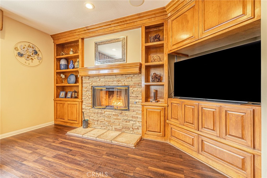 574 Oak Tree Court Simi Valley, CA 93065 - Photo 16 of 48 a view of a livingroom with wooden floor and a flat screen tv