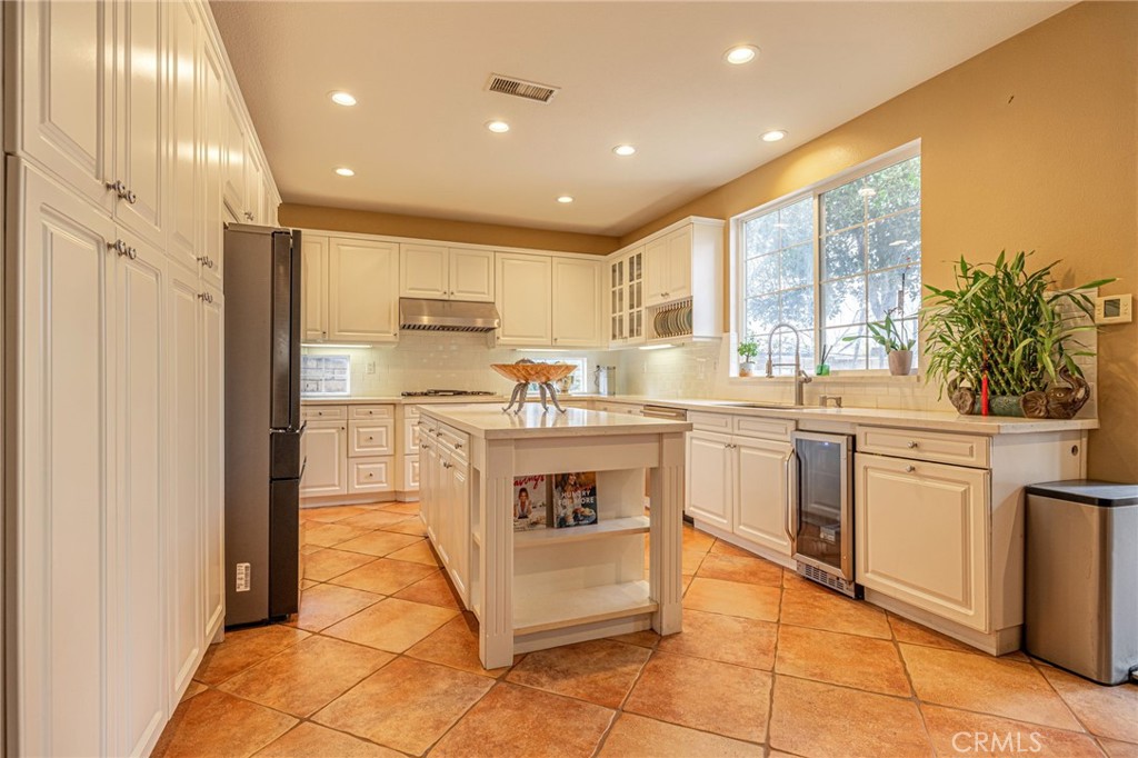 574 Oak Tree Court Simi Valley, CA 93065 - Photo 20 of 48 a kitchen with a sink a counter top space cabinets and stainless steel appliances