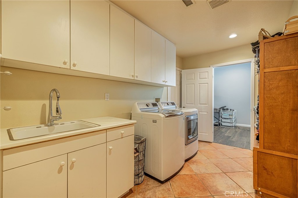 574 Oak Tree Court Simi Valley, CA 93065 - Photo 22 of 48 a utility room with dryer and washer