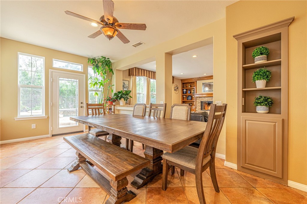 574 Oak Tree Court Simi Valley, CA 93065 - Photo 24 of 48 a dining room with stainless steel appliances a dining table and a large window with garden view
