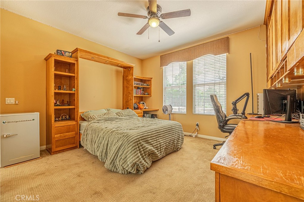 574 Oak Tree Court Simi Valley, CA 93065 - Photo 26 of 48 a bedroom with a bed and large windows