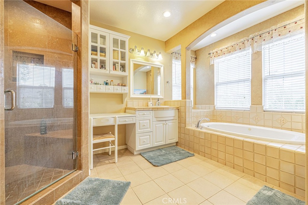 574 Oak Tree Court Simi Valley, CA 93065 - Photo 36 of 48 a bathroom with a bathtub and a shower