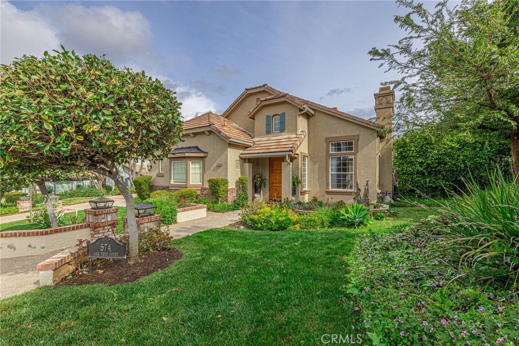 574 Oak Tree Court Simi Valley, CA 93065 - Photo 4 of 48 a front view of a house with a yard