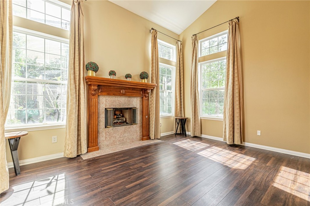 574 Oak Tree Court Simi Valley, CA 93065 - Photo 7 of 48 a view of a livingroom with wooden floor and a fireplace