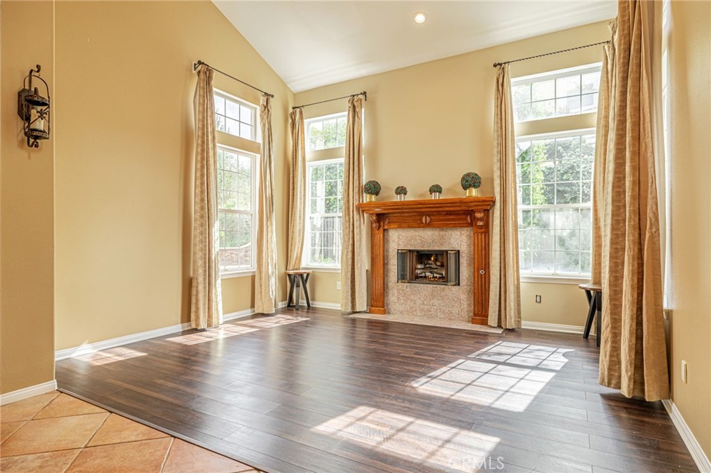 574 Oak Tree Court Simi Valley, CA 93065 - Photo 8 of 48 a view of a livingroom with wooden floor and a fireplace