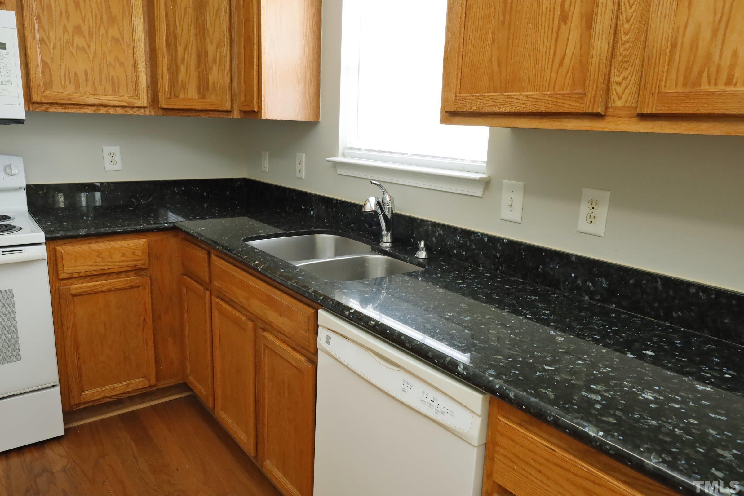 4014 Springfield Creek Drive Raleigh, NC 27616 - Photo 13 of 36 a kitchen with granite countertop stainless steel appliances sink and cabinets